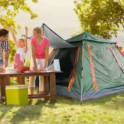 Green 4-5 person camping tent set up in a yard with open door and mesh window.
