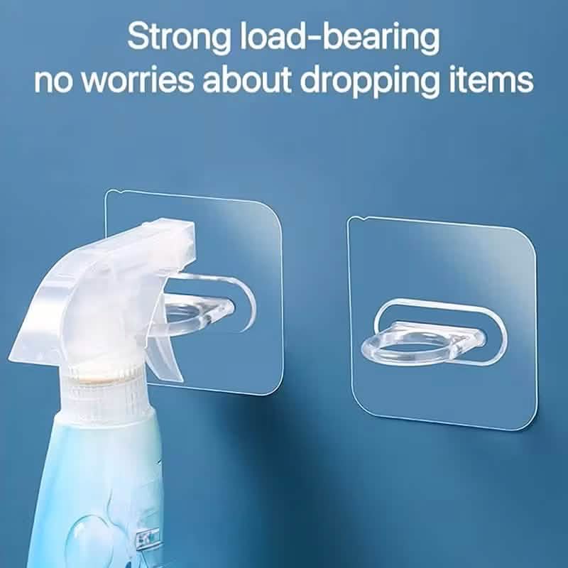 Clear adhesive hook holding a white trigger spray nozzle on a wall plate