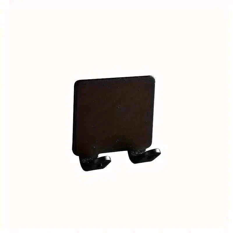 Black wall razor holder with two-prong base and adhesive mount
