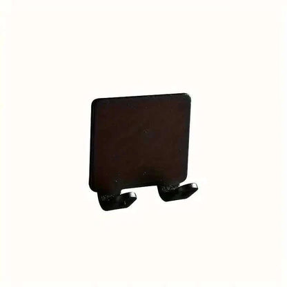 Black wall razor holder with two-prong base and adhesive mount
