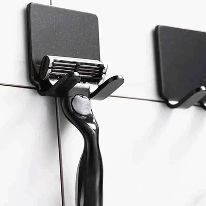 Black razor wall holder with curved grip and blade support
