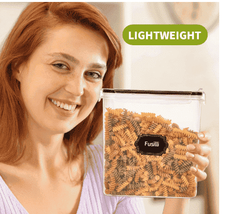 Transparent airtight cereal container with snap lid, held with pasta inside