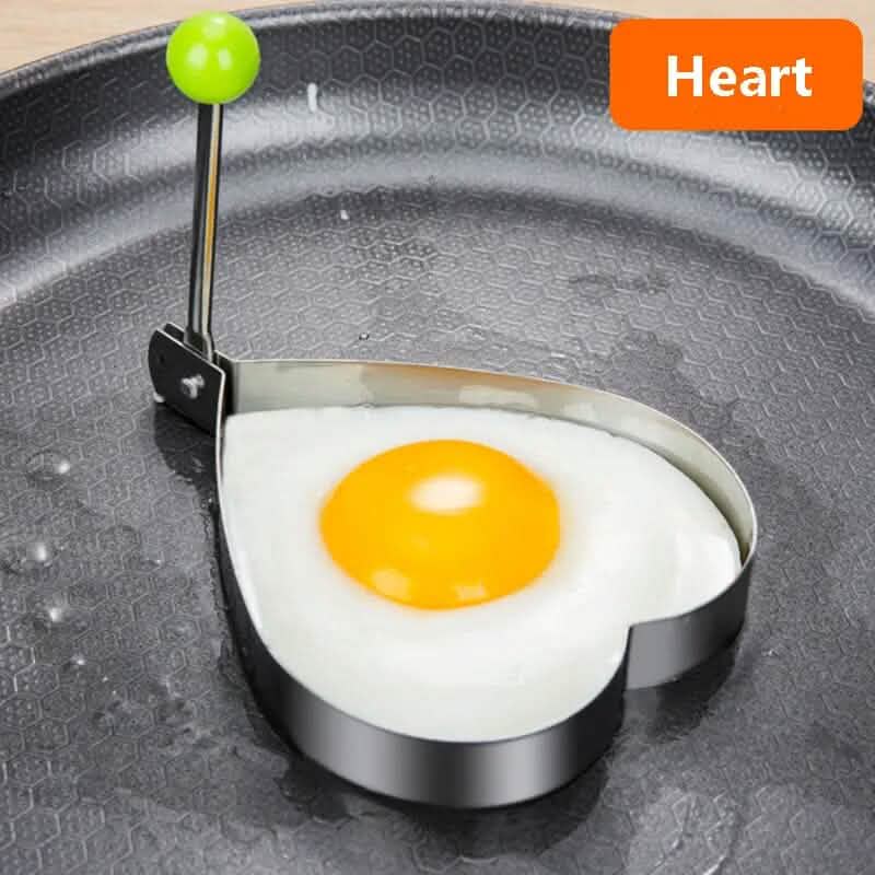 Heart-shaped egg ring mold with handle, holding a sunny-side egg