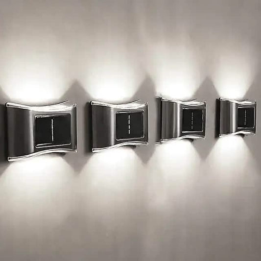 Set of four solar wall lights with chrome metal frames and dark rectangular panel windows