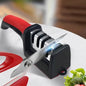 Red-and-black 4-stage kitchen knife sharpener with angled blade guide and sharpening slots