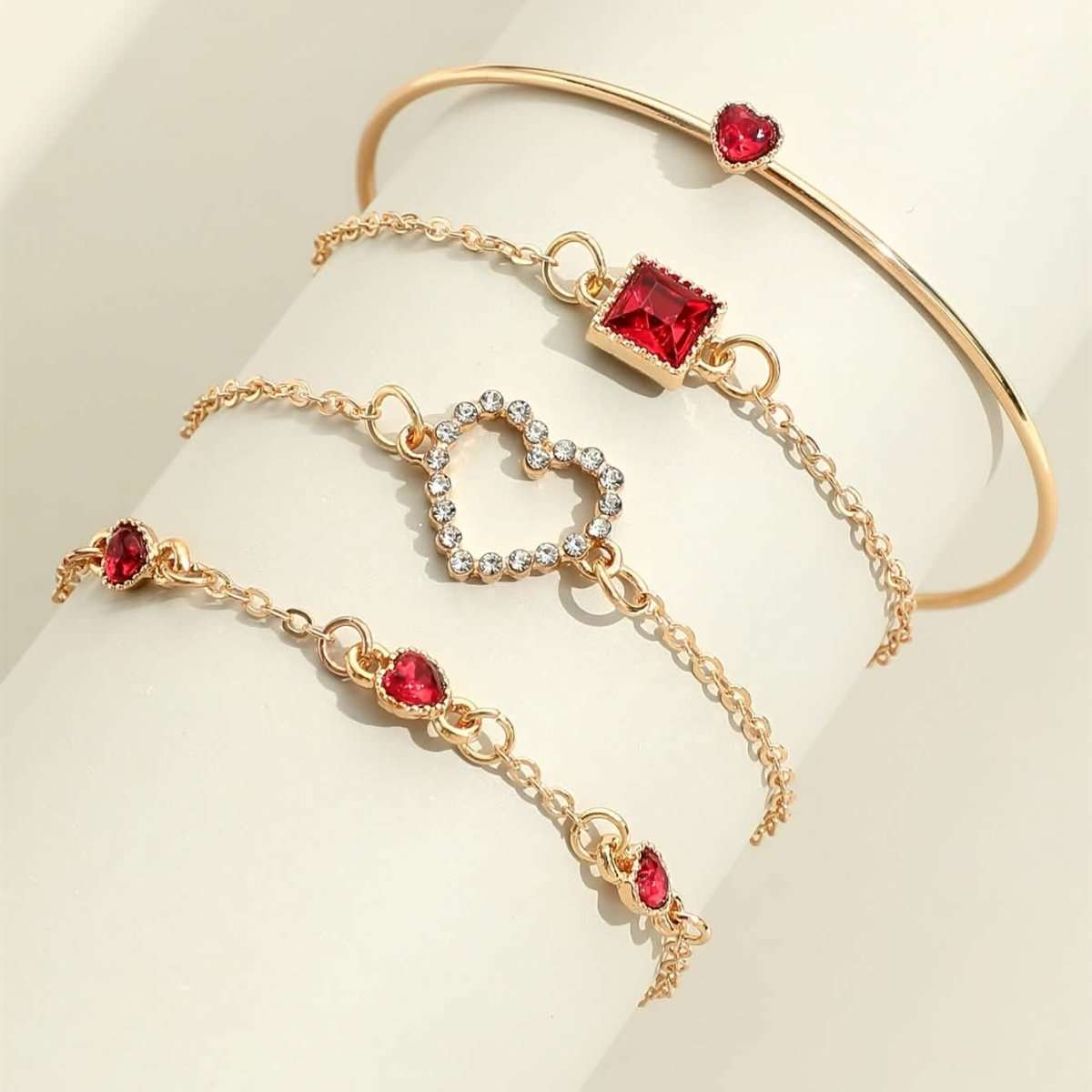 Gold-tone bracelet set with red heart and square rhinestone charms with cuff bangle.