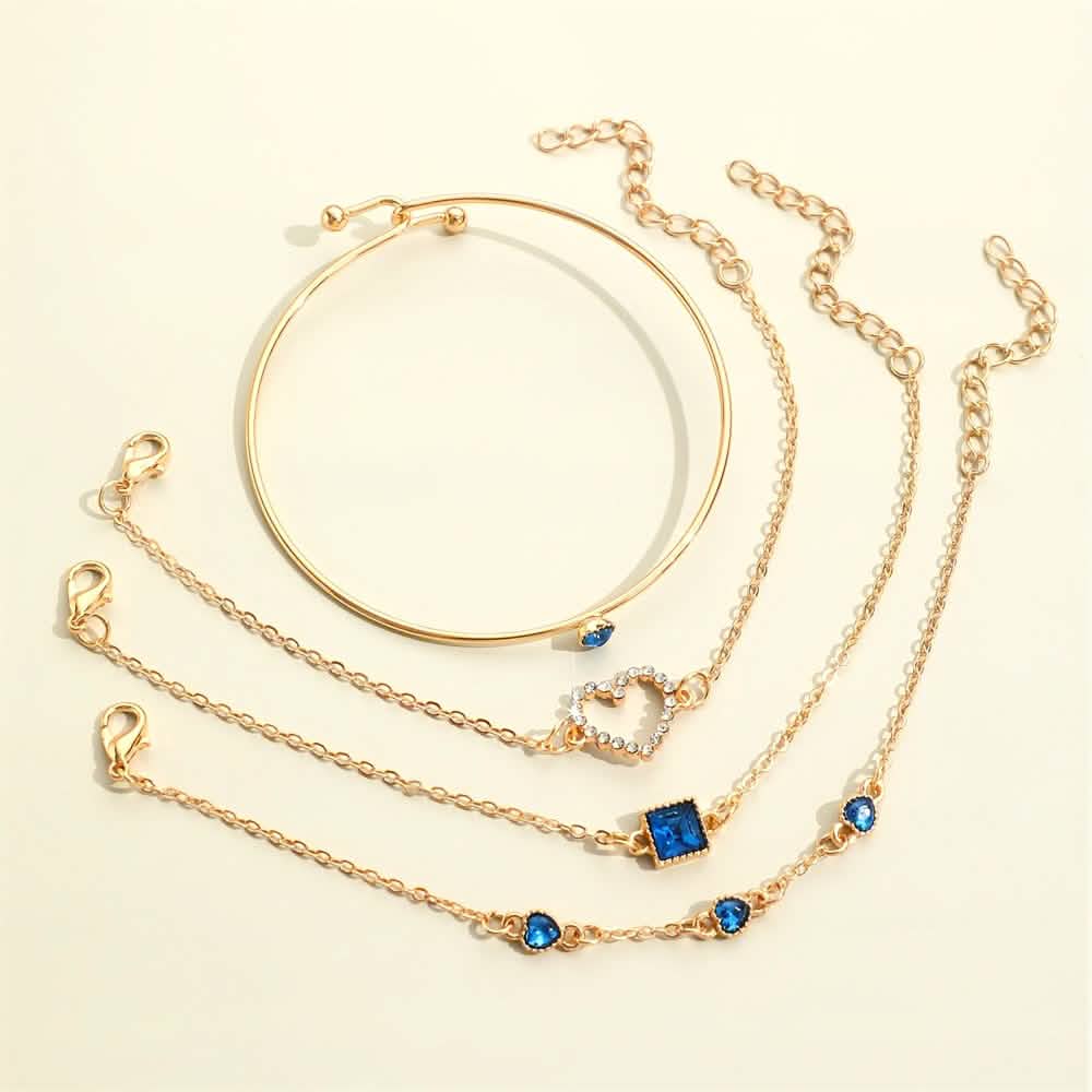 Gold-tone bracelet set with blue square and heart rhinestone charms on multiple chains.