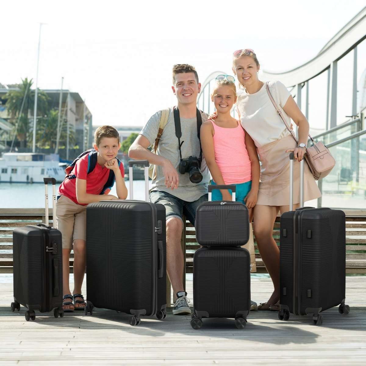 Dark rolling luggage set with telescoping handles and four-wheel small and large suitcases