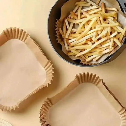 Disposable paper air fryer liners, several empty fluted cups with ribbed sides