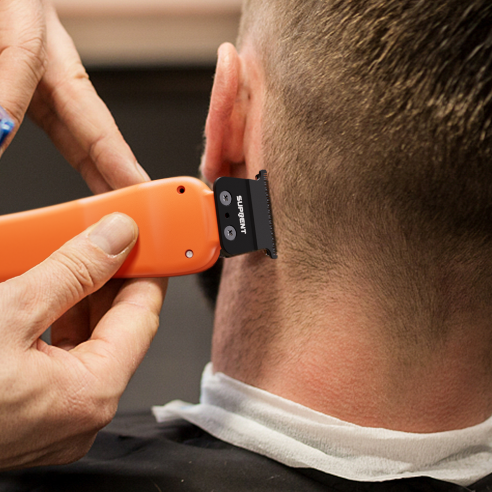 Orange cordless hair trimmer shaving neckline, black blade guard attached