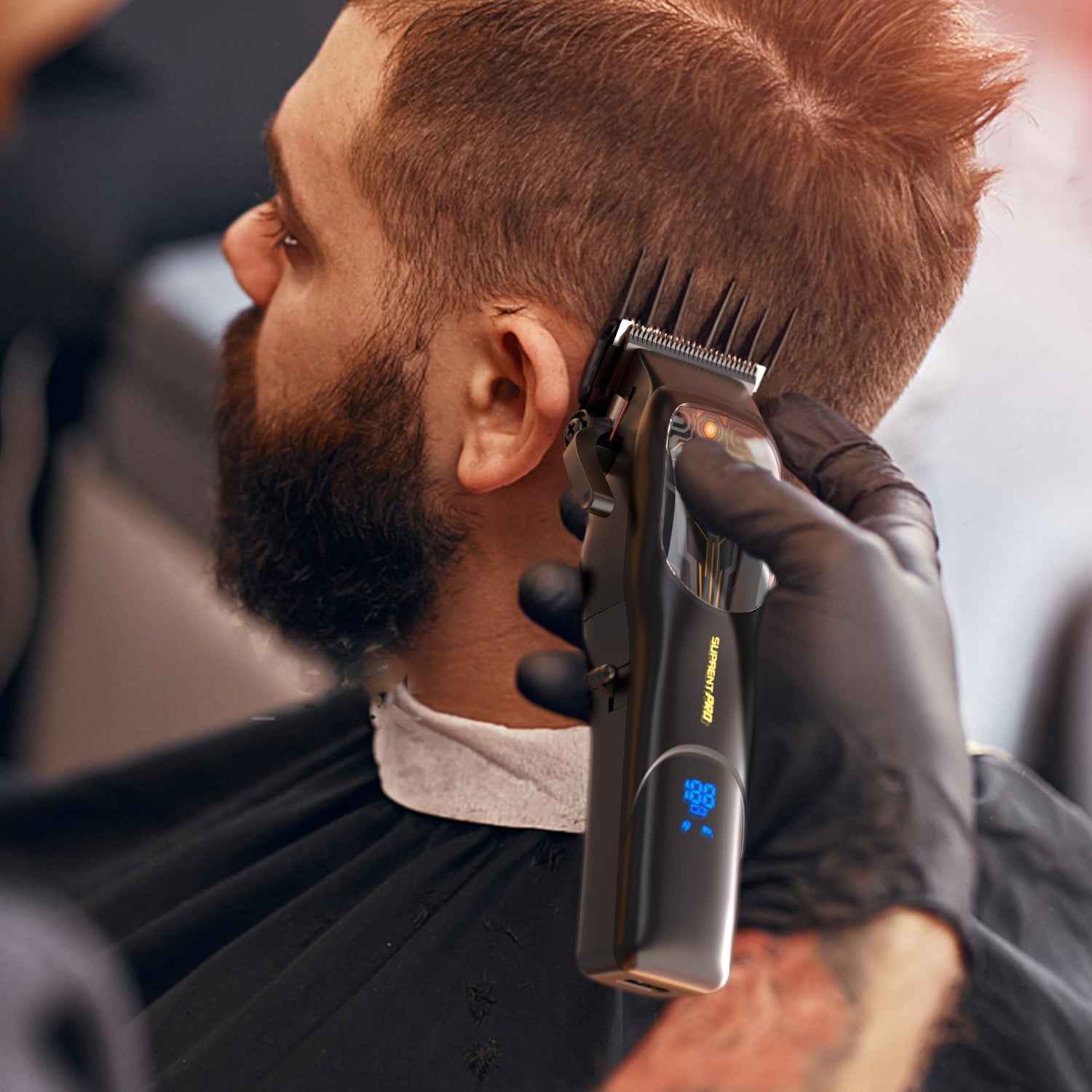 Professional hair clipper held near beard with metal guard and black body