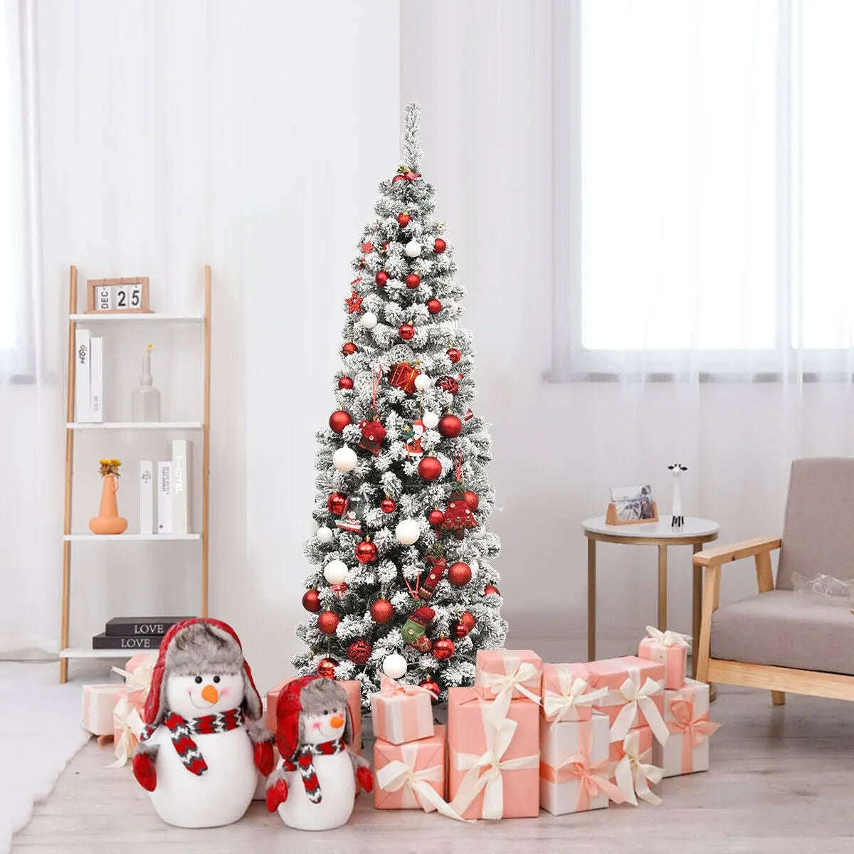 Snow flocked pencil Christmas tree with red and white ornaments and warm LED lights