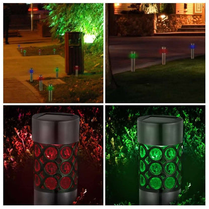 Outdoor solar garden lights in a yard emitting green and red and blue light