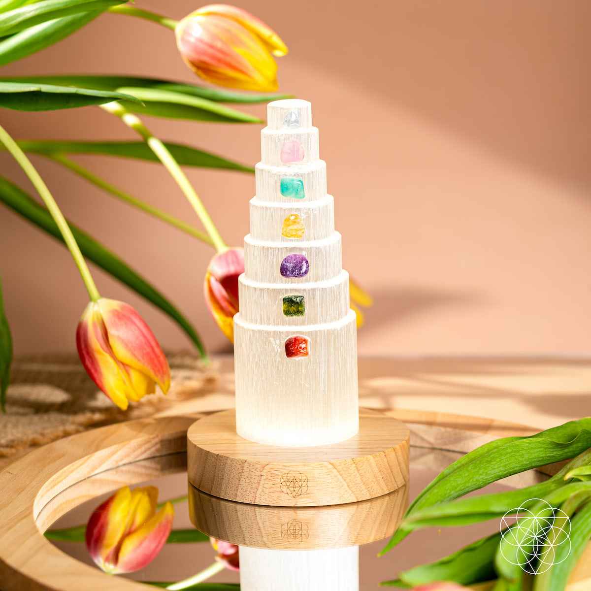 Glowing healing crystal lamp with stacked tiers and multicolor crystal insets on round wood base