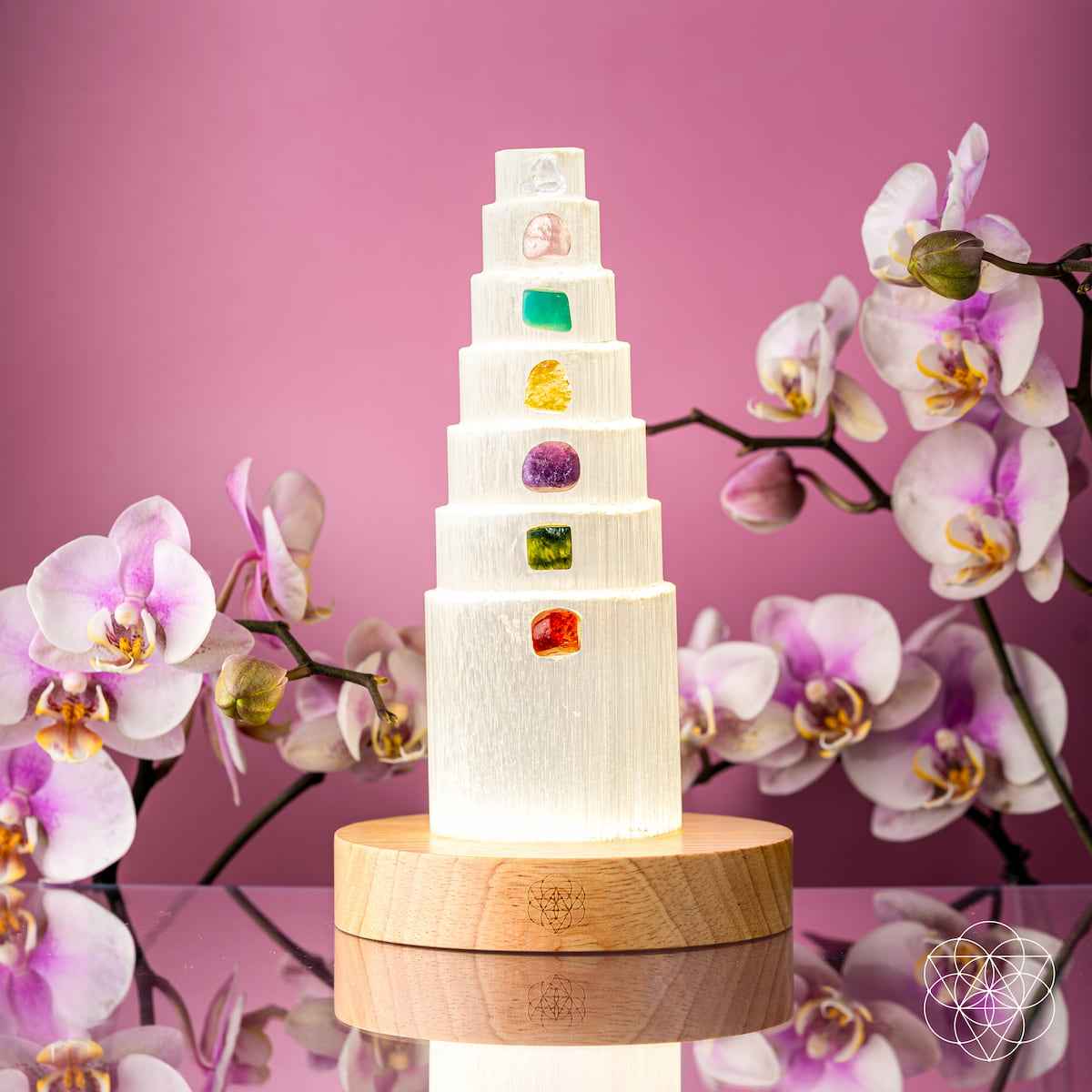 Glowing healing crystal lamp with stacked tiers and multicolor crystal insets on wood base