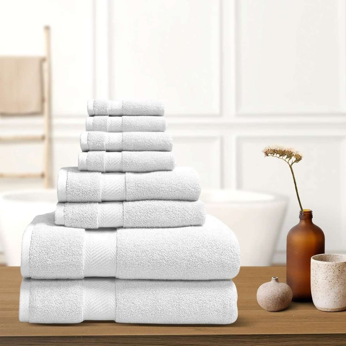 Silver bath towel stack with neatly folded terry towels, layered display