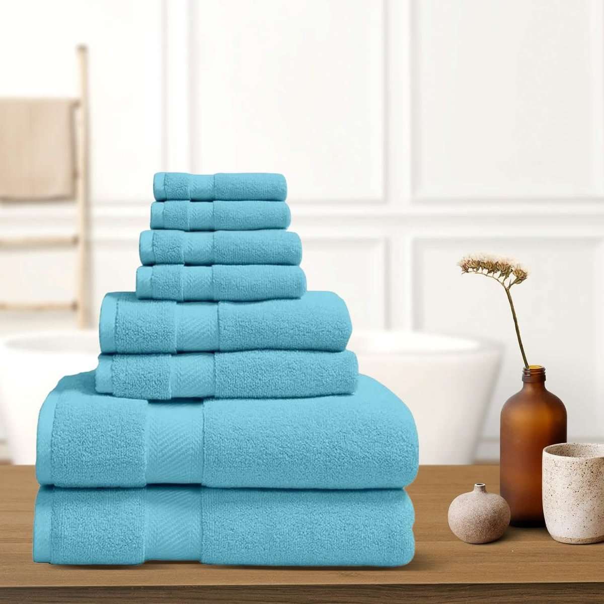 Sky blue bath towel stack with neatly folded terry towels, layered display