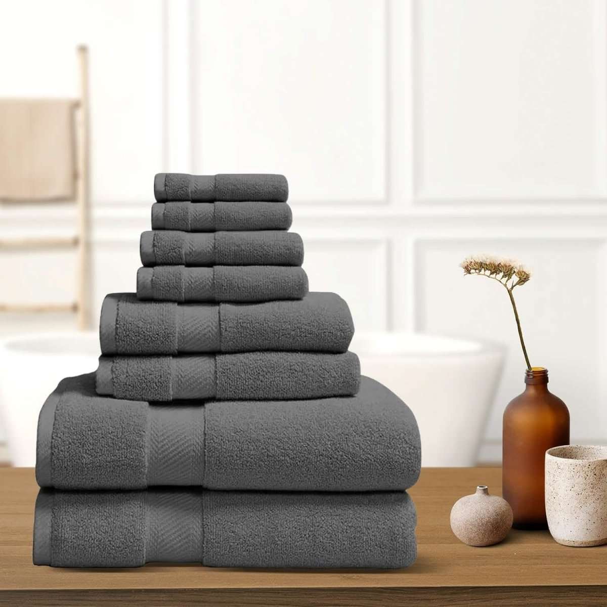 Dark gray bath towel stack with neatly folded terry towels, layered display