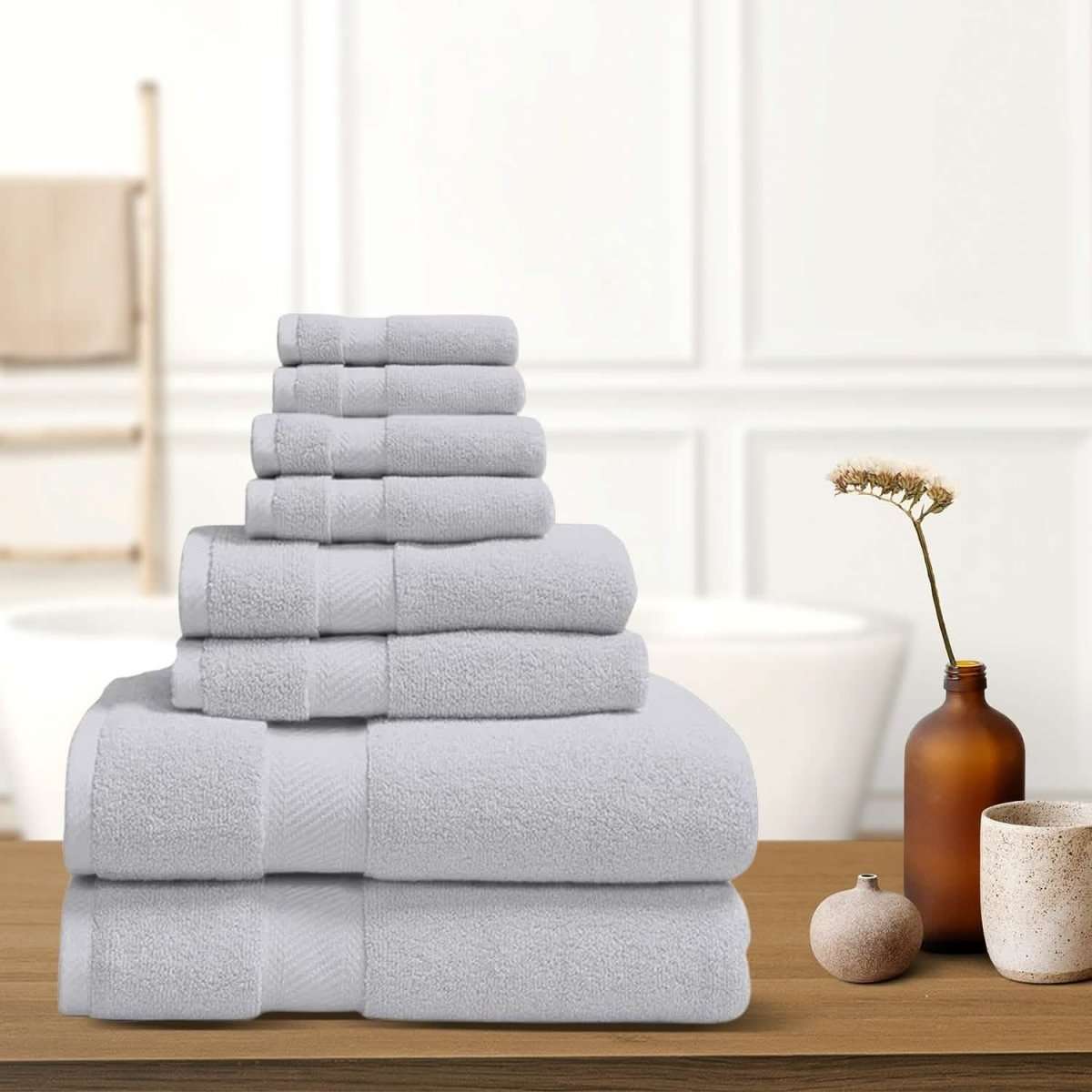 Gray bath towel stack with neatly folded terry towels, layered display