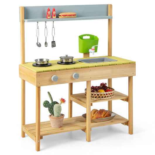Wooden pretend play toy kitchen with green stove top, shelves, and hanging utensils