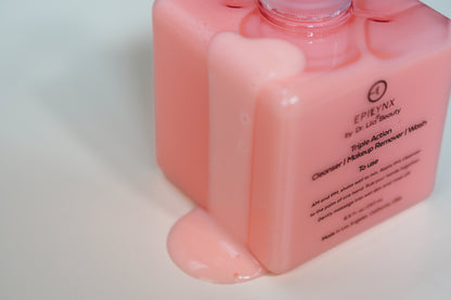 Pink facial cleanser pump bottle close-up, showing front label and glossy liquid.