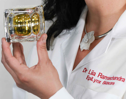 Doctor holding a clear face cream jar with gold-yellow gel, white coat