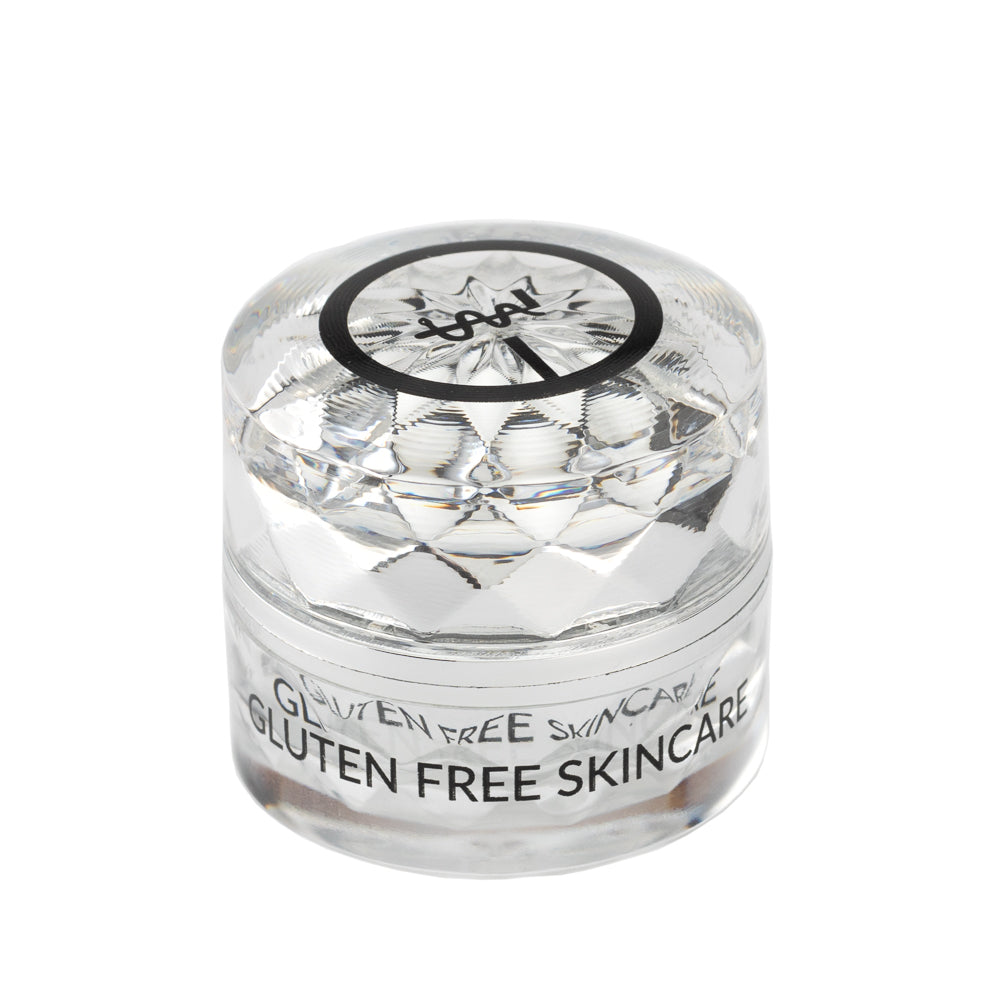 Eye cream jar with clear faceted lid and black ring logo label