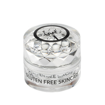 Eye cream jar with clear faceted lid and black ring logo label