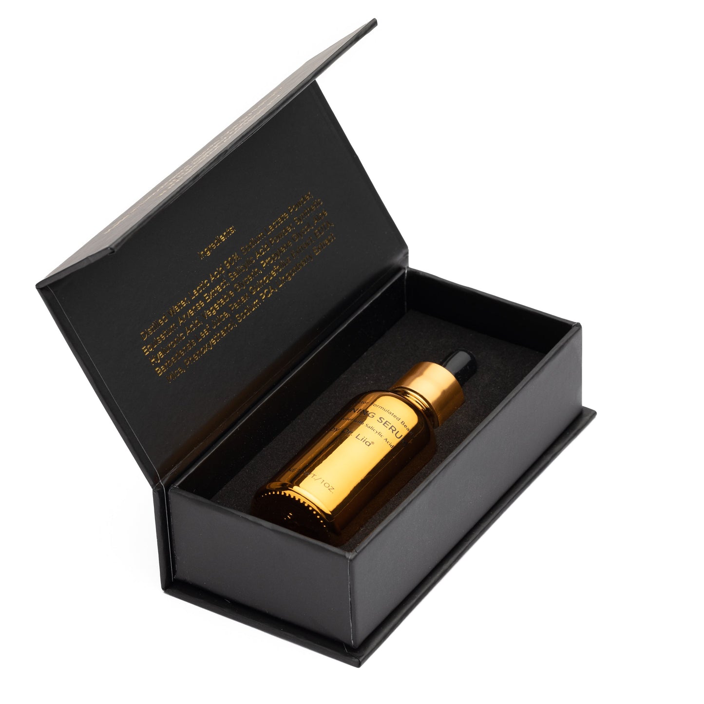 Skincare set gift box with gold serum bottle inside, black packaging