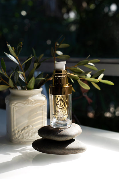 Pump serum bottle with clear glass and gold liquid, gold cap