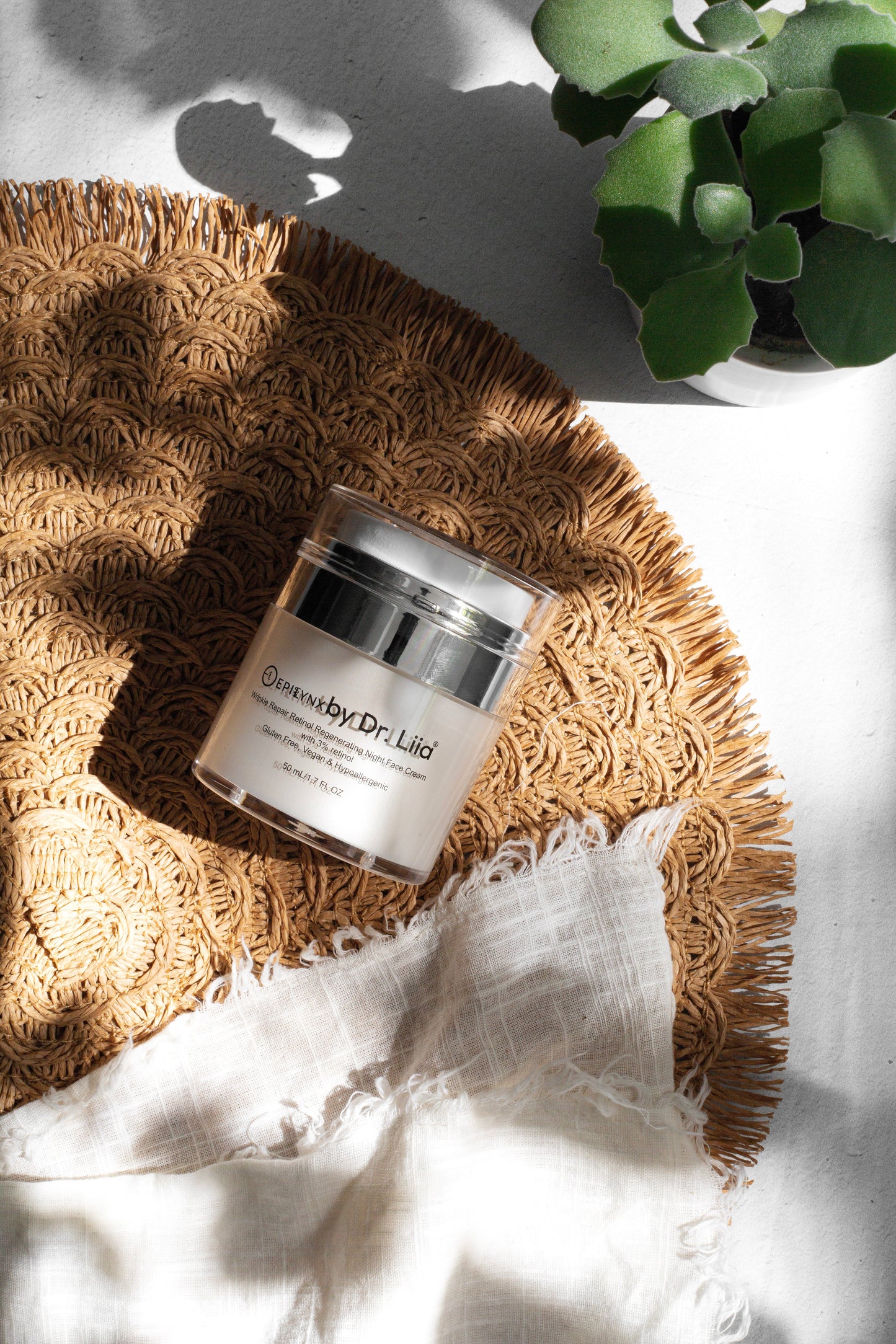 Retinol night face cream jar with chrome lid on straw mat
