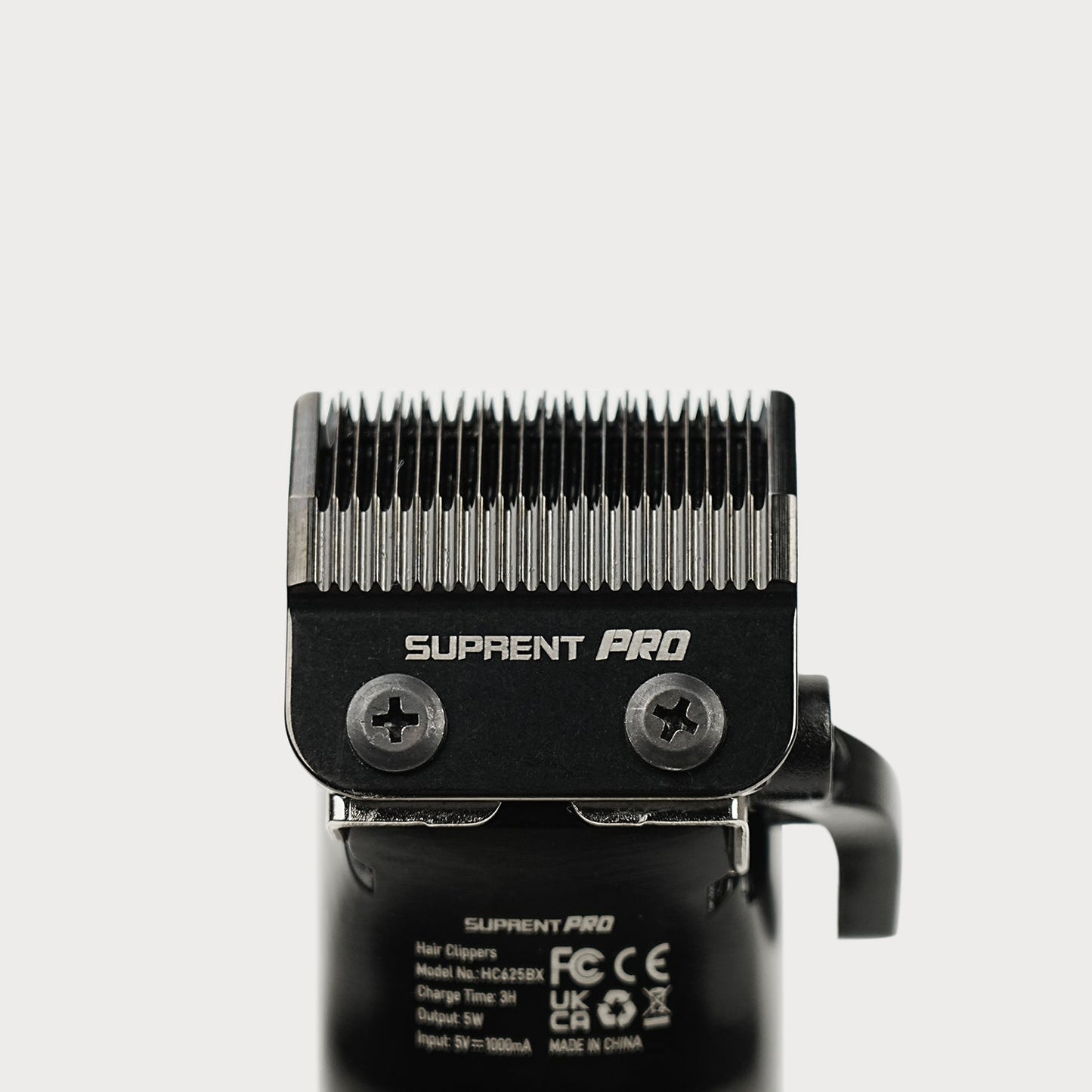 Clipper blade assembly with toothed steel cutting head on black housing