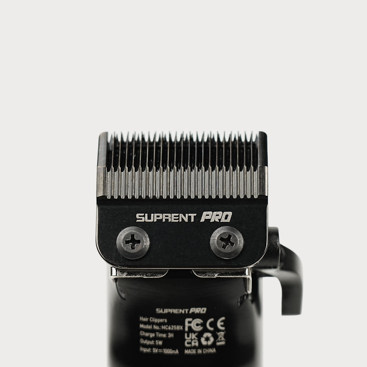 Clipper blade assembly with toothed steel cutting head on black housing