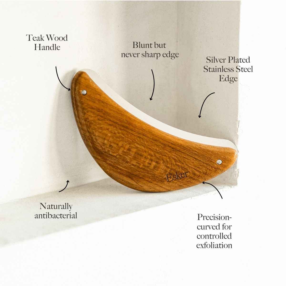 Curved wooden body exfoliator tool with silver plated steel edge and round rivet holes