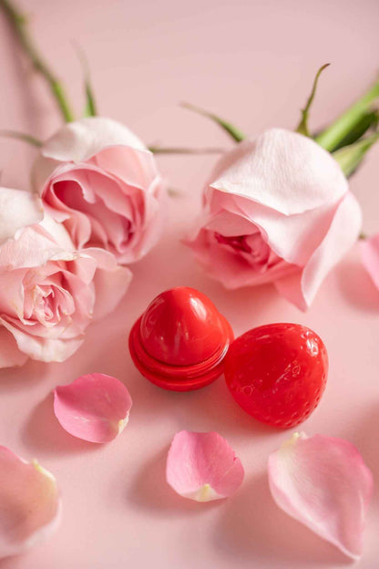 Red strawberry-shaped lip butter balm containers with glossy rounded lids