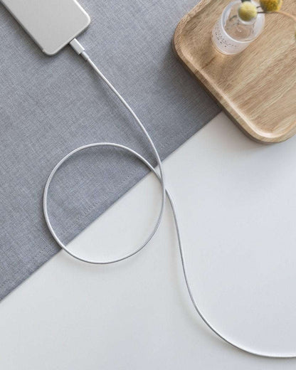 White USB-C to Lightning cable with USB-C plug and Lightning plug on a tabletop