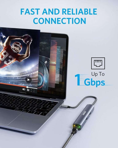 Grey USB-C hub with braided cable connected to a laptop
