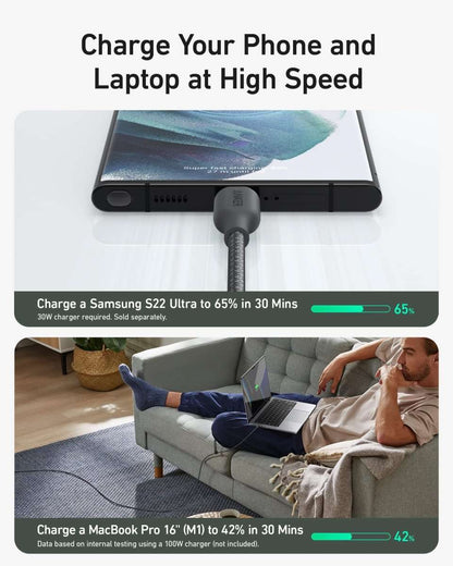 Black USB-C to USB-C cable connected to a laptop charging port with braided sleeve