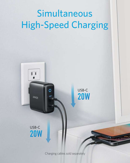 Anker 40W wall charger, black, plugged into wall with USB-C 20W ports
