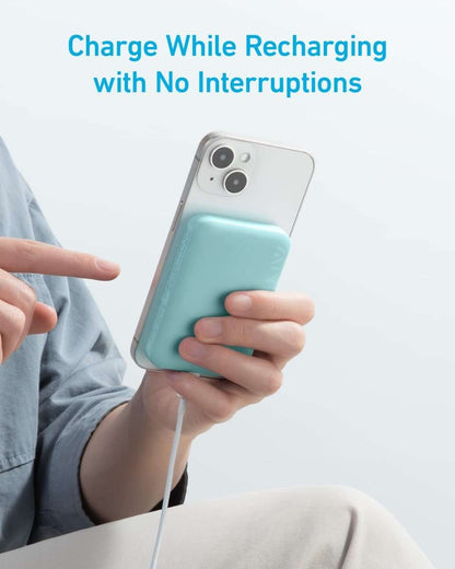 Mint-blue magnetic power bank connected to a charging cable