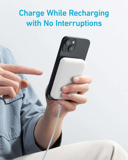 Magnetic power bank charging a phone with a cable connection, white and dark