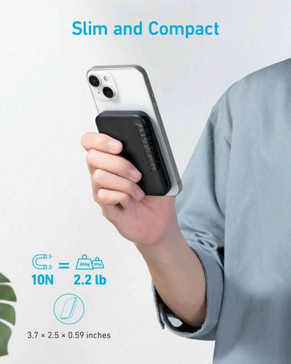 Magnetic power bank held against phone, slim white housing with black charging module