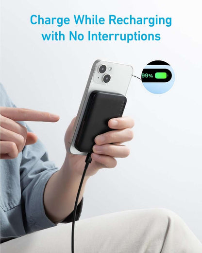 Magnetic power bank charging a phone with cable, black module shown in hand