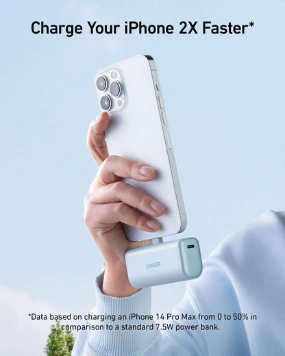 Compact power bank with built-in Lightning connector, light mint green finish.