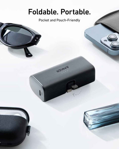 Pocket power bank with built-in Lightning connector, dark gray/black finish.