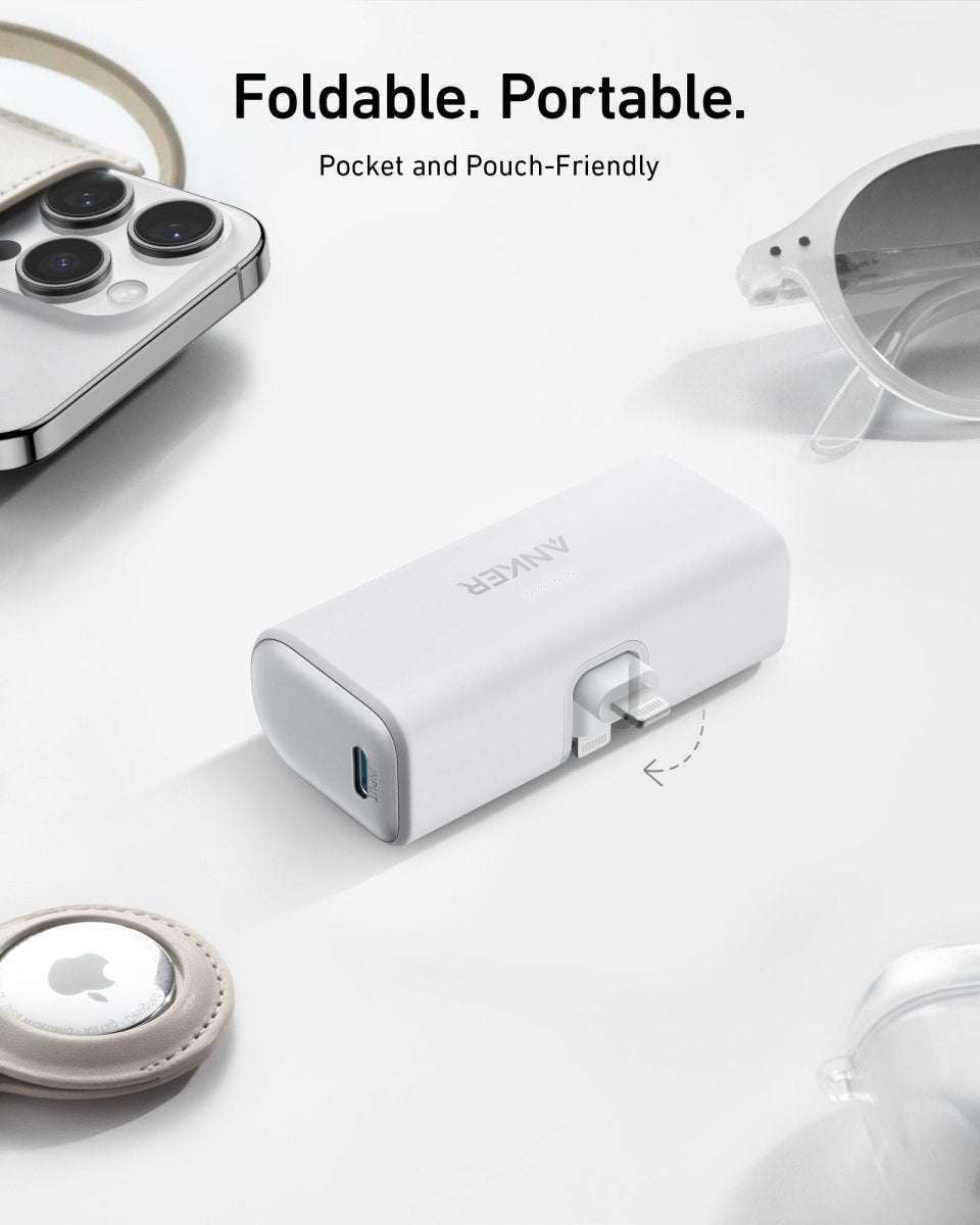 Foldable power bank with built-in Lightning connector, white finish.