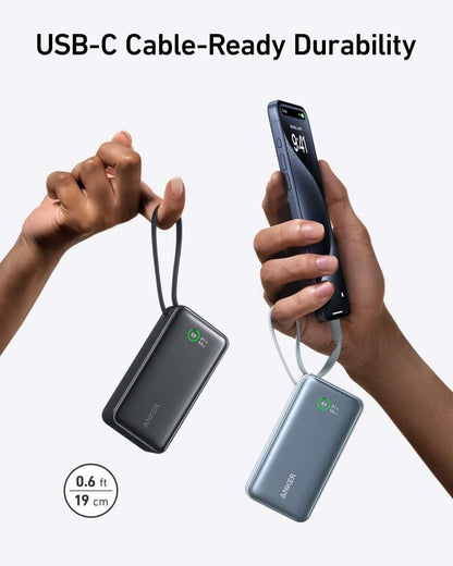 Black and blue portable power banks with built-in USB-C cable, held in hands.