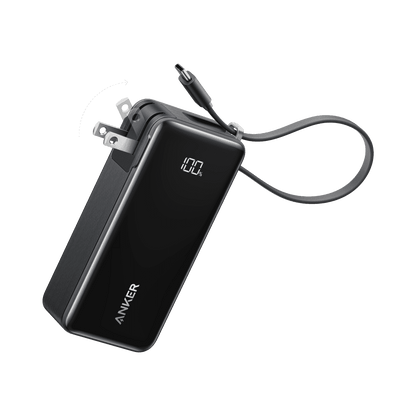 Dark power bank with built-in cable and charging port, showing battery level display