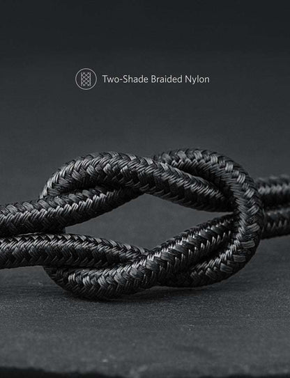 Two-tone black braided nylon cable, coiled close-up