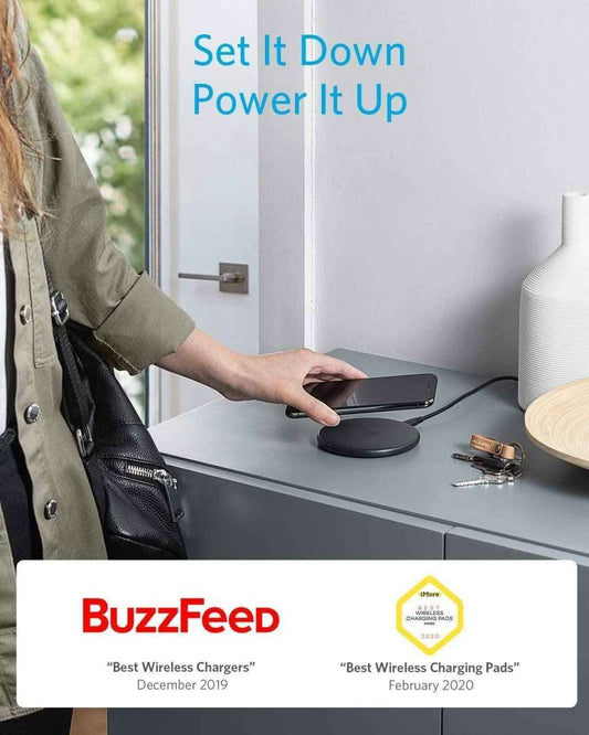 Wireless charging pad on a desk with a phone resting on top
